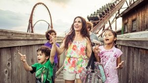 mom and kids about to ride a roller coaster